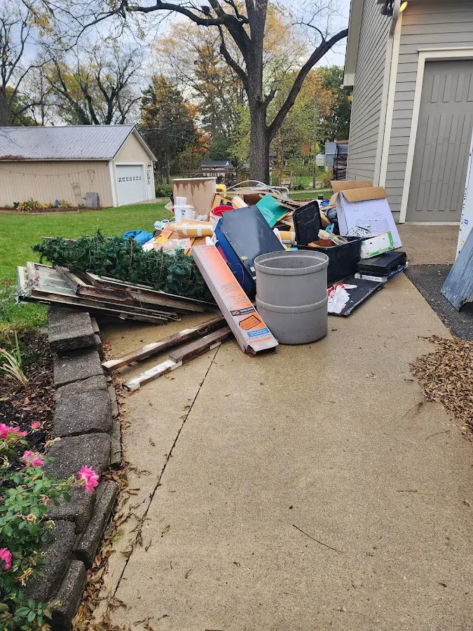 Dumpster being loaded with debris for 12 Yard Dumpster Rental in Dundee